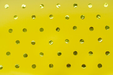 Yellow background of shiny dots.