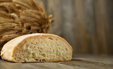 Sliced fresh bread on a wooden rustic background