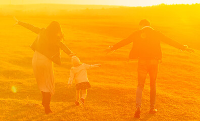 Fototapeta premium Anonymous family having fun at sunset