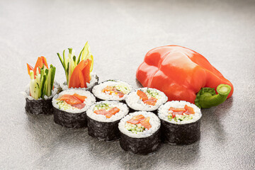 sushi rolls 8 pieces on a stone surface