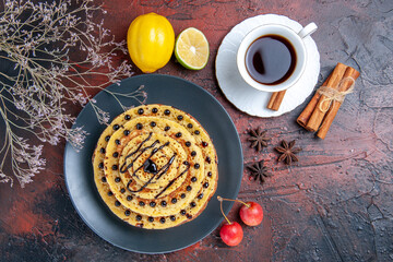 top view yummy sweet pancakes with tea on dark background cake milk sweet dessert