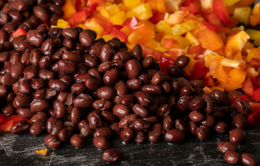 Corn, black beans and bell peppers being prepared for a meal.