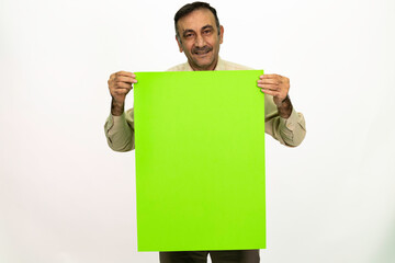 Man holding billboard in his hand. The man is dressed in a white shirt and fabric pants. Isolated image on white background.