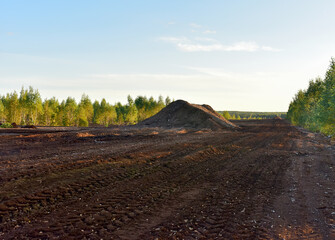 Landscape on peatlands where being development of the peat. Drainage of peat bogs at extraction site. Drilling on bog for oil exploration. Wetlands declining and under threat.