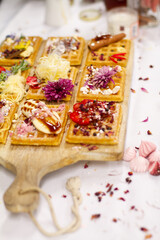Waffles on board decorated with bananas and strawberries
