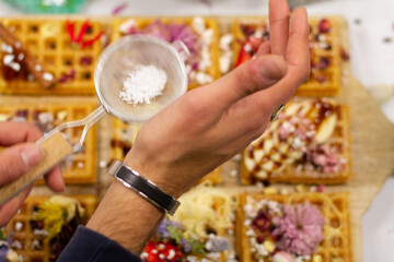 Waffles on board decorated with bananas and strawberries
