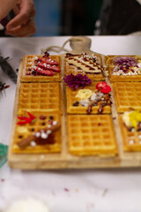 Waffles on board decorated with bananas and strawberries
