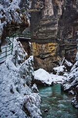 Wanderweg an schneebefallener Klamm entlang