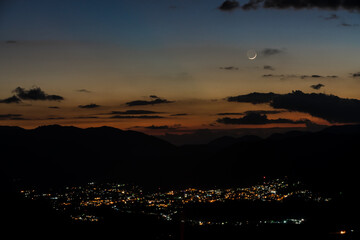 dramatic sunset with moon over San Jose De Ocoa, in the caribbean mountains of the dominican republic
