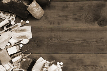 A lot of narcotic substances and devices for the preparation of drugs lie on an old wooden table