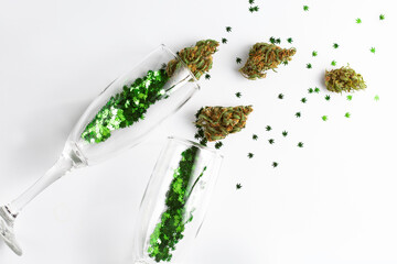 Cannabis in champagne flutes cheers for celebration. Cannabis confetti concept for New Years,...