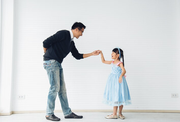 Father is teaching his little daughter to dance in the halls of the house. Happy holidays, family relationships.