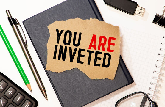 paper with text YOU ARE INVETED. Business concept