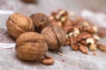 Whole walnuts and split on table. kernels of walnuts are dried and ready to eat. Soft focus. Blured picture.