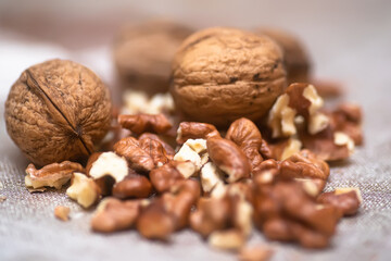 Whole walnuts and split on table. kernels of walnuts are dried and ready to eat. Soft focus. Blured picture.
