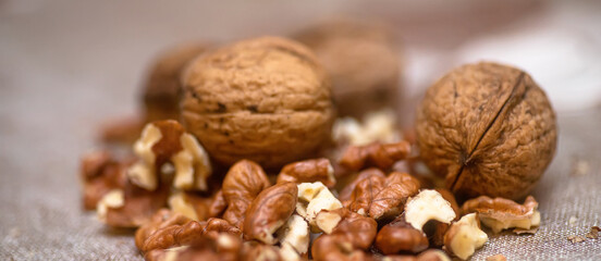 Whole walnuts and split on table. kernels of walnuts are dried and ready to eat. Soft focus. Blured picture.