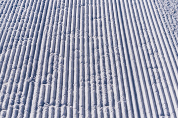 Snow lines texture made from a snow machine on a ski slope. snow traces