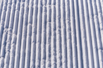 Snow lines texture made from a snow machine on a ski slope. snow traces