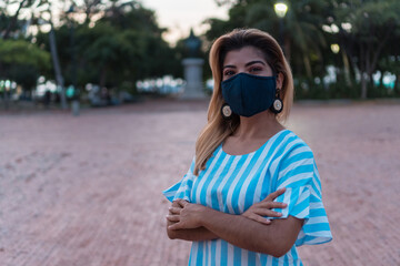 Woman with protective mask crossed arms