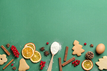 Flat lay composition with Christmas cookies and flour on green background. Space for text