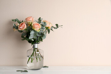 Vase with bouquet of beautiful roses on white wooden table. Space for text - Powered by Adobe