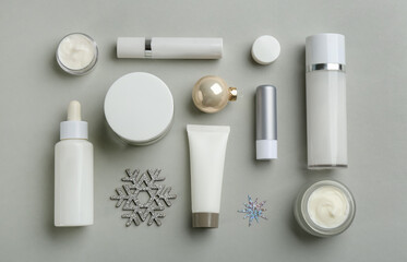 Flat lay composition with different cosmetic products on light grey background. Winter care