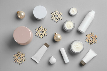 Flat lay composition with different cosmetic products on light grey background. Winter care