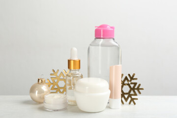 Beautiful composition with different cosmetic products on white table. Winter care