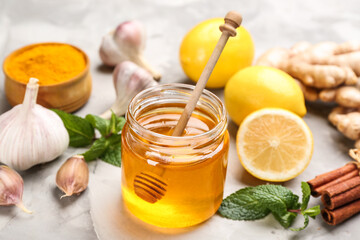Honey and other fresh products on grey table. Natural antibiotics