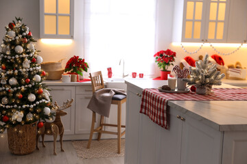Beautiful kitchen interior with Christmas tree and festive decor