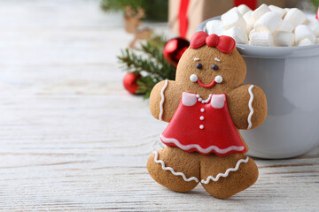 Gingerbread girl white wooden table, closeup. Space for text