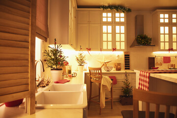 Small Christmas trees and festive decor in kitchen
