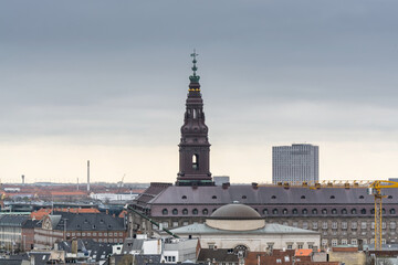 Aerial view of old downtown of Copenhagen City from the The Round Tower (Rundetaarn),  and Christiansborg Palace, a palace and government building on the islet of Slotsholmen in central Copenhagen