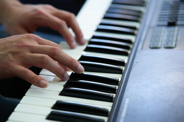 close-up detail of the pianist's fingers while playing his piano softly