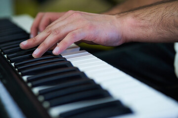 close-up detail of the pianist's fingers while playing his instrument
