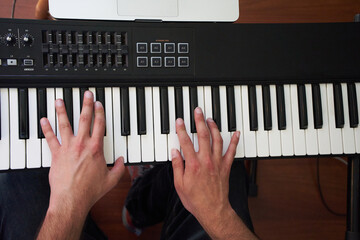overhead shot of the hands of a pianist playing his instrument