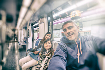 Happy family riding the city subway train