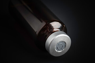 Macro Image Of Amber Vaccine Vial In Black Background