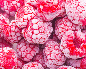 close up of frozen raspberries on background