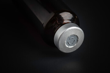 Macro Image Of Amber Vaccine Vial In Black Background