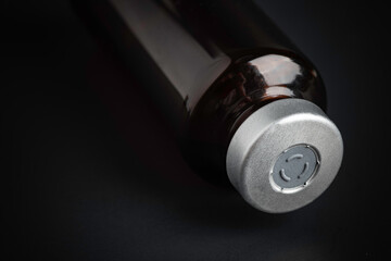 Macro Image Of Amber Vaccine Vial In Black Background