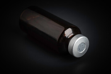 Macro Image Of Amber Vaccine Vial In Black Background