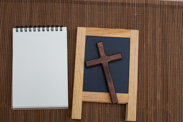 Small wooden board or black board with wooden cross.