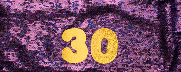 Gold numbers 30 on sequins glitter purple background