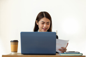 Young Asian businesswoman working with laptop at her house, work from home, business concept
