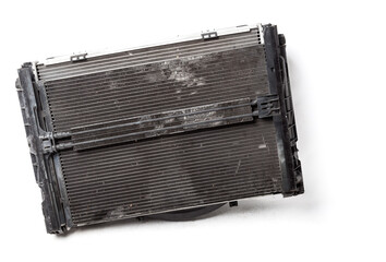 Fototapeta premium The old cooling radiator is a metal heat exchanger inside filled with antifreeze. Repair in the workshop. Parts Catalog.