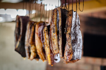 Traditional smoked pork muscles hung on dry
