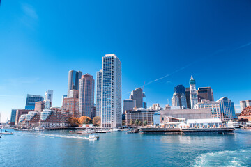Fototapeta na wymiar Boston skyline from a moving boat on a beautiful sunny day, Massachusetts