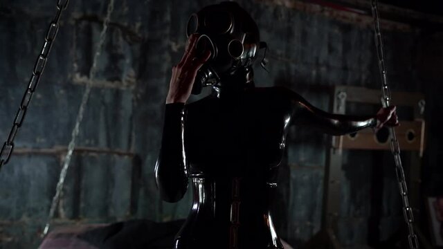 sex roleplay in bdsm club, woman dressed latex suit with face mask, unrecognisable lady