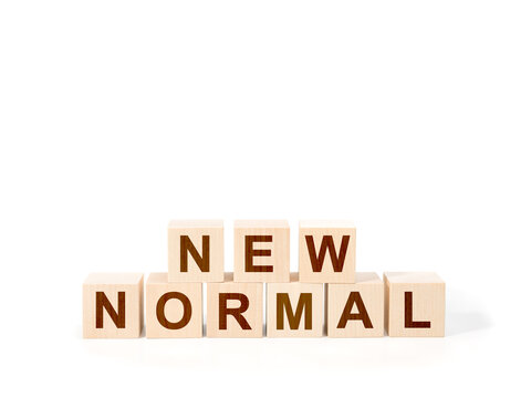 NEW NORMAL text on wooden cube. White background. close up. word new normal on wooden cubes against white background.